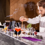 bartender pouring cocktail incredients. Lounge atmosphere